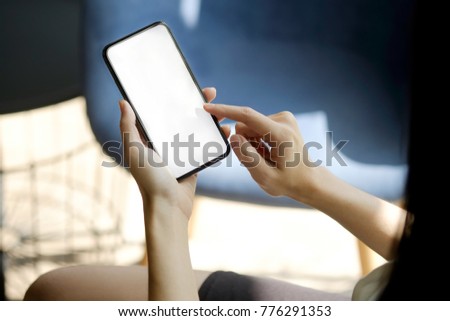 Cropped shot of an unrecognizable businesswoman using a mobile phone at office. Blank screen smart phone for graphic display montage.