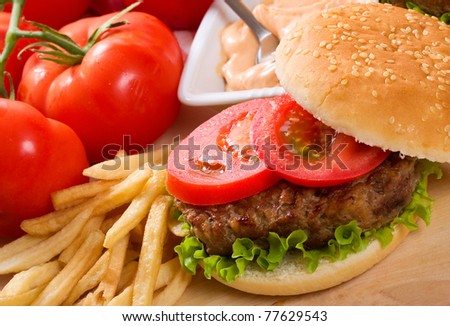 hamburger with fries and vegetables
