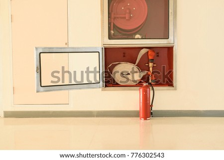 Rescue firefighter equipment, extinguisher, ax and fire line in red box.