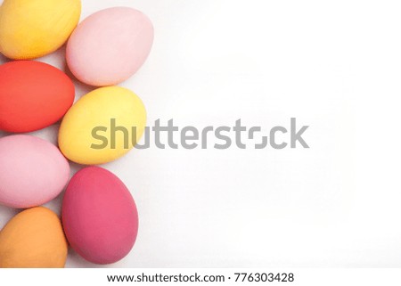 Easter composition with 
colored eggs on wooden white background with copy space