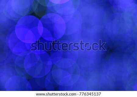Picture blurred for abstract background, bokeh loop effect, out of focus lights of a street at night 