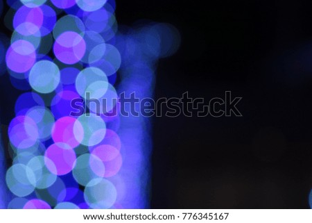 Picture blurred for abstract background, bokeh loop effect, out of focus lights of a street at night 