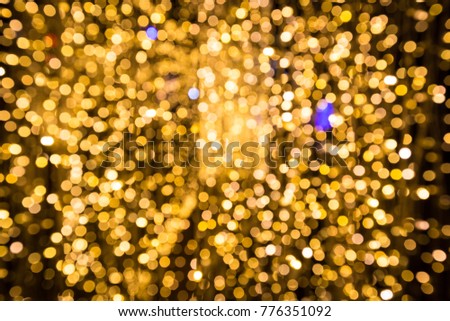 Yellow bokeh of blurry LED light decoration for happy new year celebration in night for background.