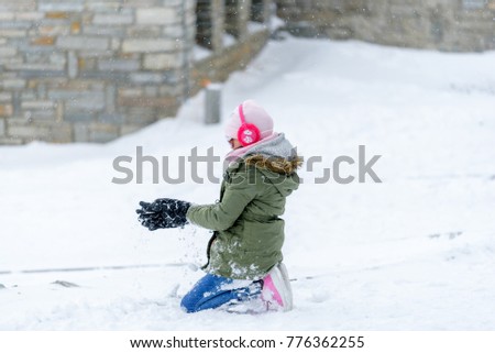 Kid enjoy snow during winter