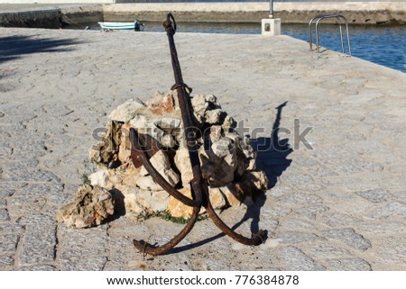 Old rusty anchor in the habor
