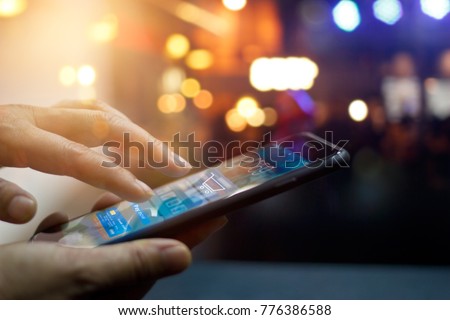 Mobile payment, Man using mobile payments online shopping and icon on night background, All on screen and credit card are design up. Royalty-Free Stock Photo #776386588