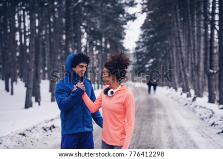 Young couple doing a high five after a successful workout