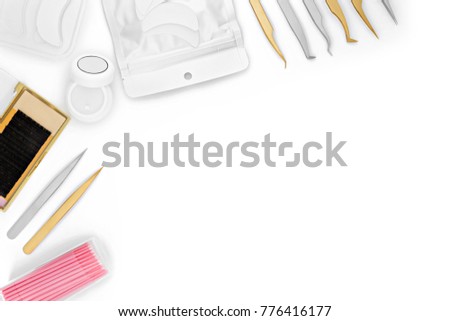 set accessory cosmetics for artificial or fake eyelashes, metal tweezers, copy space, white background 