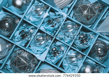 Big Set of Luxury Silver Glass Baubles. Retro styled image of vintage Christmas decoration in a box. Christmas holidays composition. box filled with christmas silver baubles. 