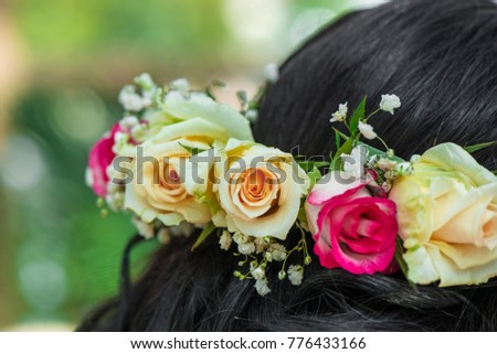 Female hair with beautiful colorful flower crown. Cheerful bride and bridesmaids party before wedding
