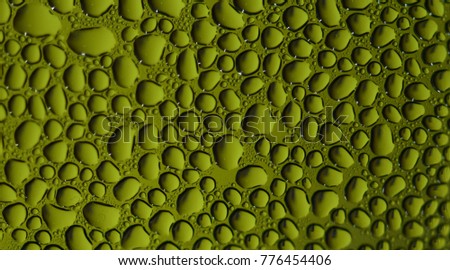 Drops of water on the glass, in different colors (green)