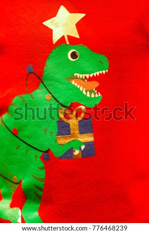 Creative green T-Rex Christmas tree print screen on on knitting sweater.