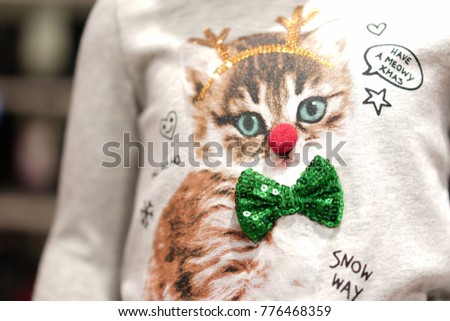 Cat suit reindeer headband screen on kid shirt.