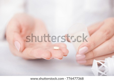 woman's hands with pills