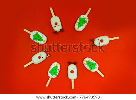 Christmas dessert and decorations. ice cream and candy decorated as Christmas composition with Santa Claus, Reindeers and Christmas trees. 