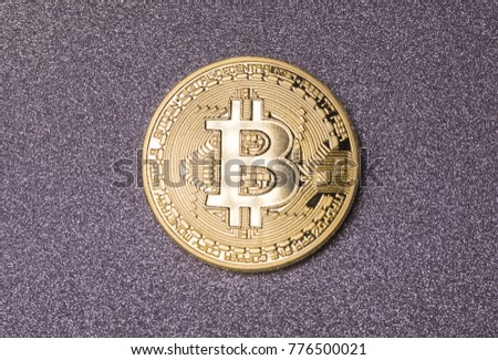 Gold bitcoins on glitter background with space for copy. Photo (new virtual money). New crypto currency coins.