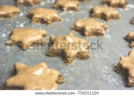 Closeup of a batch of frosted star shaped cinnamon cookies ready to be baked - Traditional Christmas cookies - Alsace, France