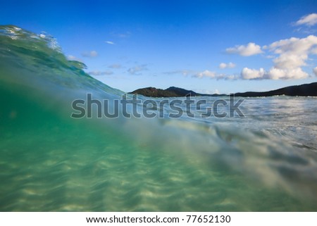 water incoming wave cover white sand silica beach clear transparent sea edge of surf blue sky