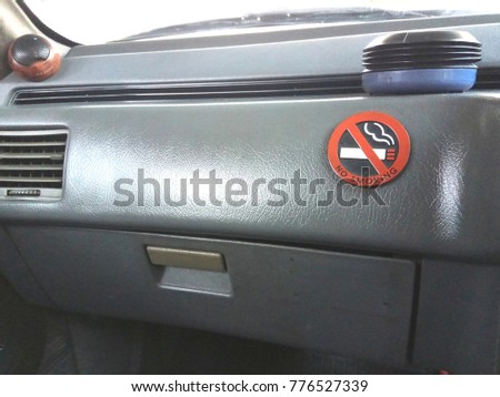 no smoking  sign in the car