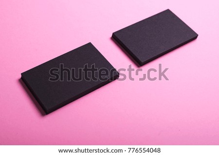 Business cards of black color on pink background. Mockup.