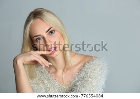 portrait of a beautiful stylish young girl with a pensive face on a light background
