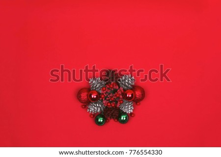 Mistletoe and christmas ornaments on red background