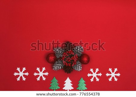 Snowflakes with christmas decorations on red background
