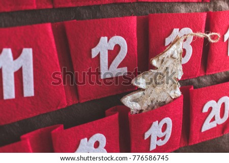 Close up view of a red Advent calendar with Christmas decoration, Christmas, Advent or winter holidays concept, vintage view