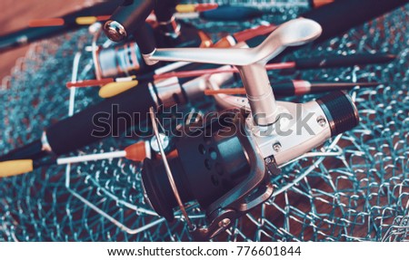 Fishing equipment on a old wooden table. Sport and recreation concept