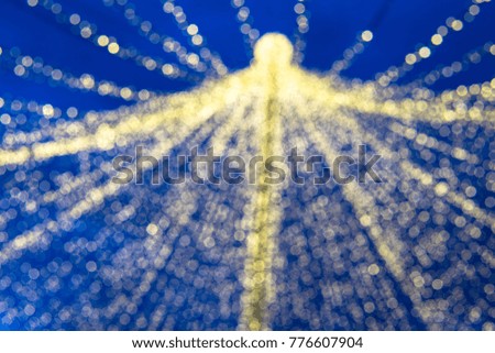 Abstract, colorful, blurry Christmas background. Glowing and sparkling lights during night.