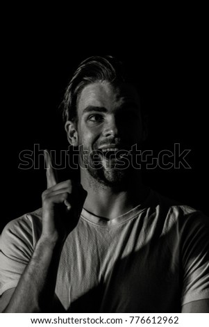 Man has an idea on the dark background. The cool man has an idea about business.