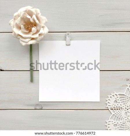 Card on a wooden background with a pink peony in the style of shabby chic