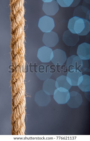 rope on a blue background with blurry lights