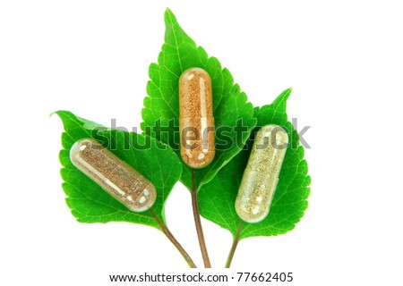 herbal capsules on melissa leaves Royalty-Free Stock Photo #77662405