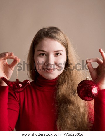 Woman hands holding red Christmas tree toy in her hands. Female hands with a red toy. Hands holding big shiny tree toy on studio background. New Year holiday 2018 concept. Woman waiting for holidays.