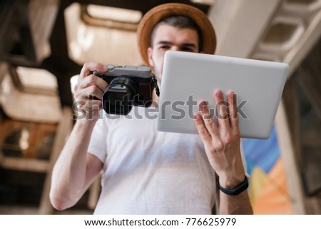 advanced modern photography practices. tablet and photo camera connection to see photos in high resolution. contemporary technology concept