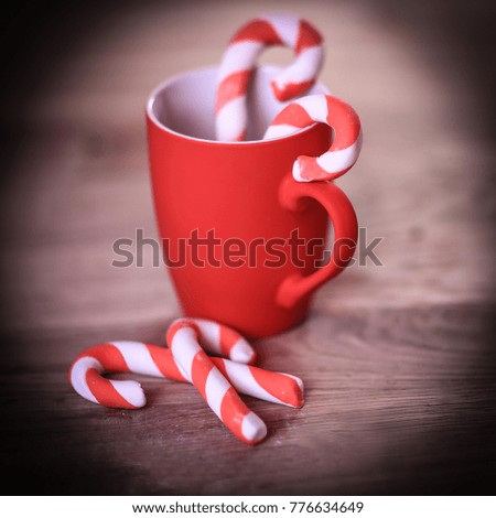 Christmas mug and candle on wooden background
