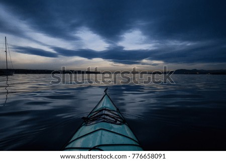 Kayaking during a beautiful and vibrant winter sunset. Taken near Downtown Vancouver, British Columbia, Canada.