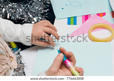 Children using art equipment to draw and make pictures, close up of hands