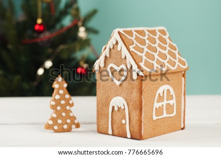 Gingerbread house and gingerbread tree on a light blue background, copy space. Homemade sweetness for Xmas, New Year 2022, banner for site, flyer, invitation