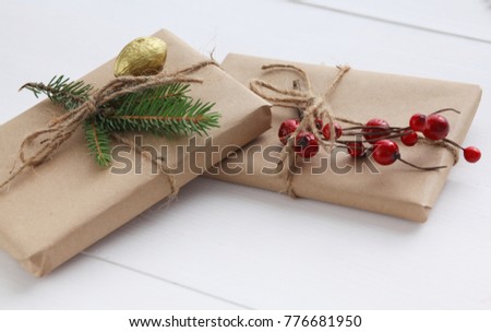 Christmas gift boxes and fir tree branch on wooden table. ?hristmas background