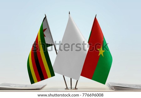 Flags of Zimbabwe and Burkina Faso with a white flag in the middle