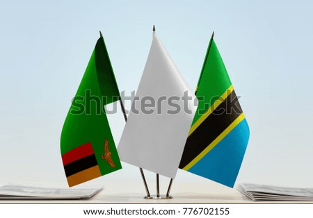 Flags of Zambia and Tanzania with a white flag in the middle