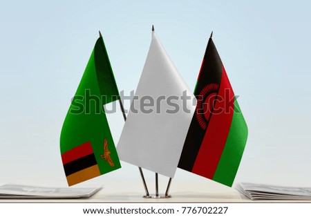 Flags of Zambia and Malawi with a white flag in the middle
