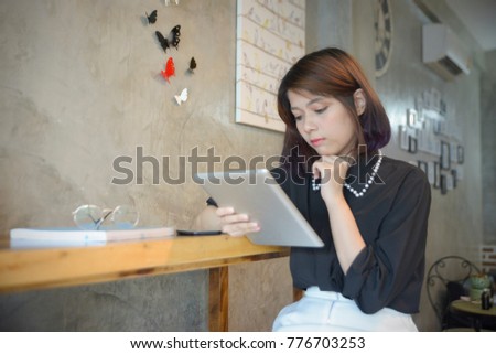 Asian teenage women browsing a tablet searching information from internet online to seek the knowledge and preparing for examination