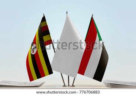 Flags of Uganda and Sudan with a white flag in the middle