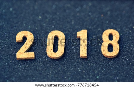 Happy New 2018 on black glitter blur background