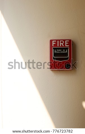 The red fire alarm and the communication equipment on the white wall, in concept of safety