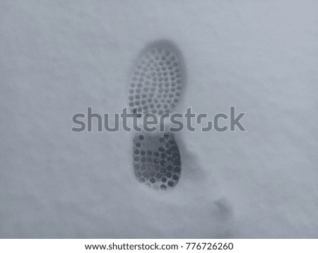 Human foot prints of shoes on snow