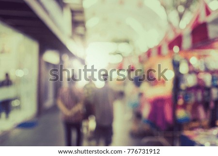 Blurred group of people shopping in the market with vintage tone.